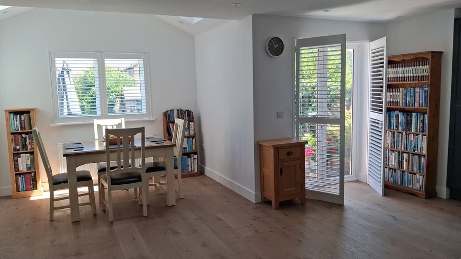 Open plan dining area with plantation shutters and oak flooring