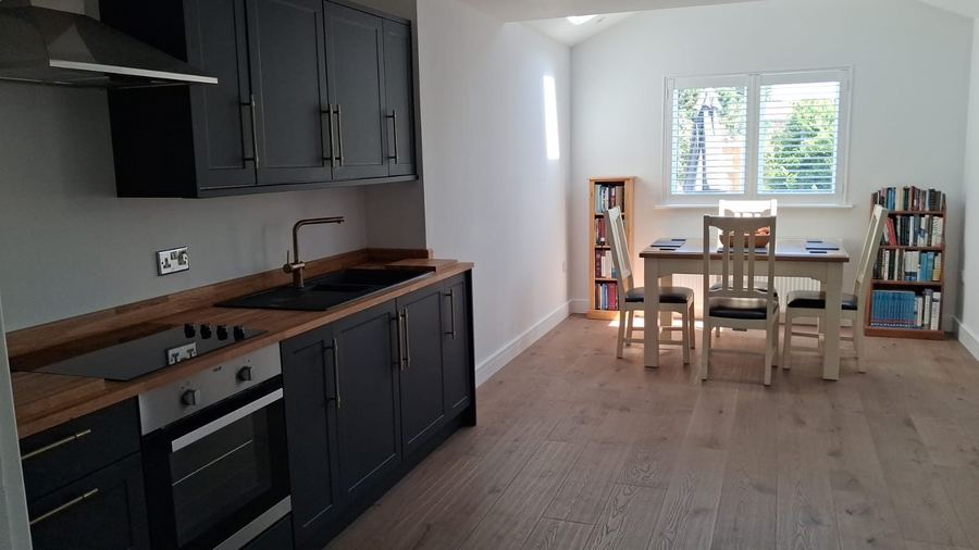 Navy shaker kitchen with solid timber worktops